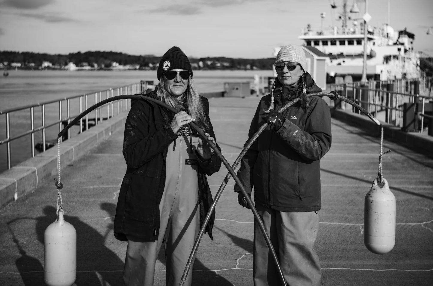 Black and white photo of women kelp farmers with buoys